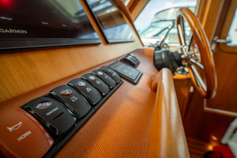 Slide: The Image of Control panel of 2015 Sabre 48 Salon Express yacht with wooden steering wheel. - 19
