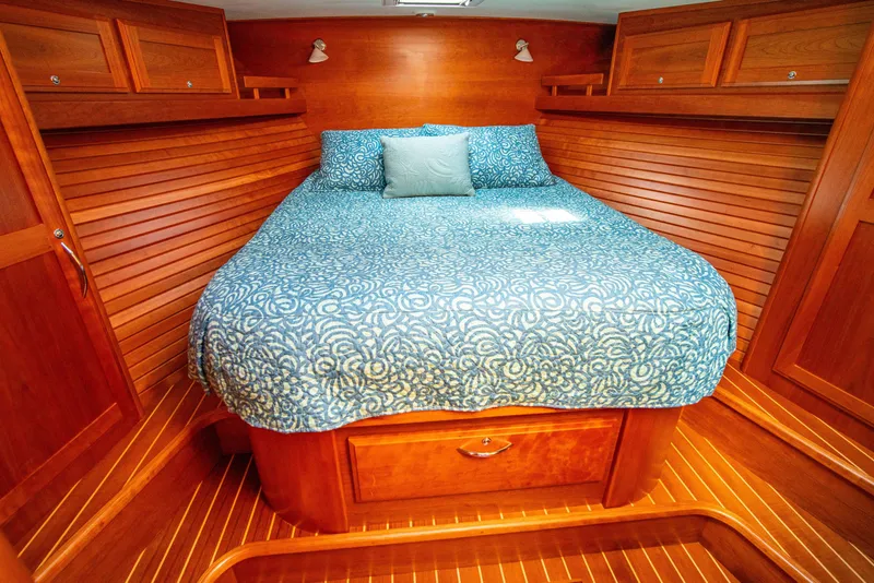 Slide: The Image of Luxurious 2015 Sabre 48 Salon Express cabin with cozy bed and wooden interior. - 2