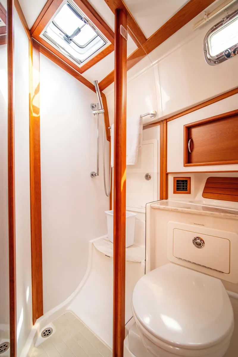Slide: The Image of 2015 Sabre 48 Salon Express bathroom with wood accents and skylight. - 20