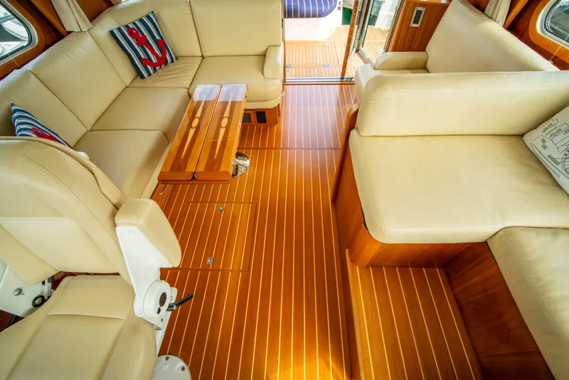 Slide: The Image of Interior of 2015 Sabre 48 Salon Express with beige seating and wooden flooring. - 21