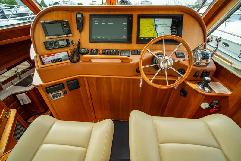 Slide: The Image of Interior helm of 2015 Sabre 48 Salon Express with navigation screens and steering wheel. - 22