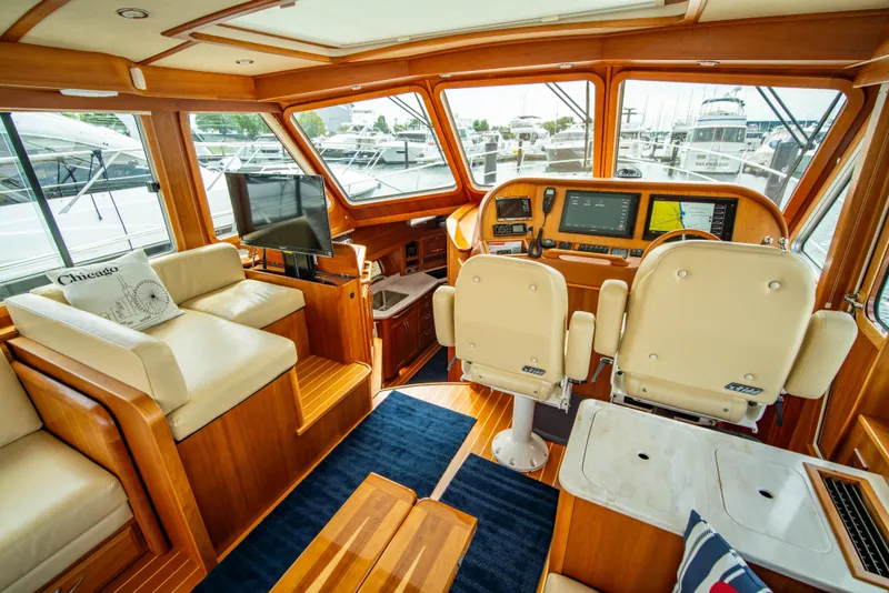 Slide: The Image of Interior of 2015 Sabre 48 Salon Express yacht with luxurious seating and navigation equipment. - 27