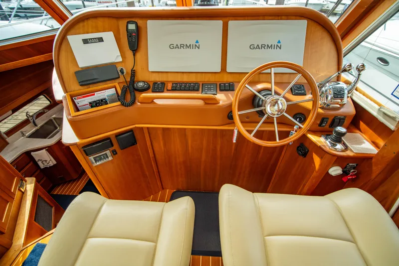 Slide: The Image of 2015 Sabre 48 Salon Express helm with Garmin navigation and wooden steering wheel. - 28