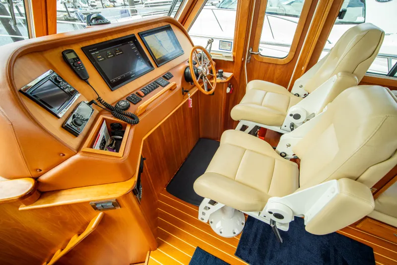 Slide: The Image of Interior of 2015 Sabre 48 Salon Express yacht with leather seats and navigation controls. - 29
