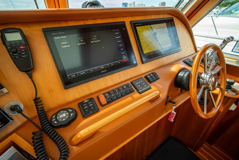 Slide: The Image of 2015 Sabre 48 Salon Express helm with navigation screens and controls. - 3