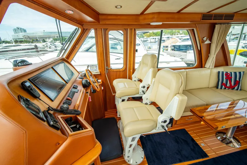 Slide: The Image of Interior of 2015 Sabre 48 Salon Express yacht with luxurious seating and navigation equipment. - 31