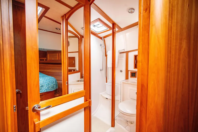Slide: The Image of 2015 Sabre 48 Salon Express yacht bathroom with wooden accents and skylight. - 36