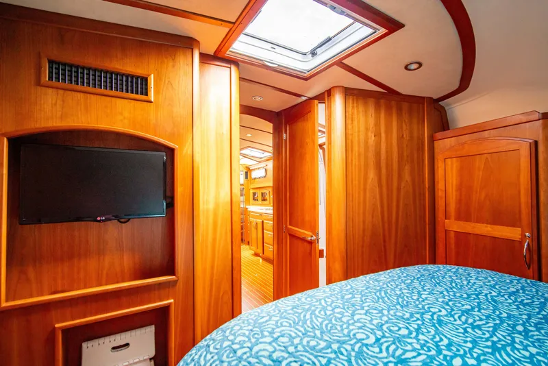 Slide: The Image of Interior of 2015 Sabre 48 Salon Express, featuring wood paneling and a cozy cabin. - 37