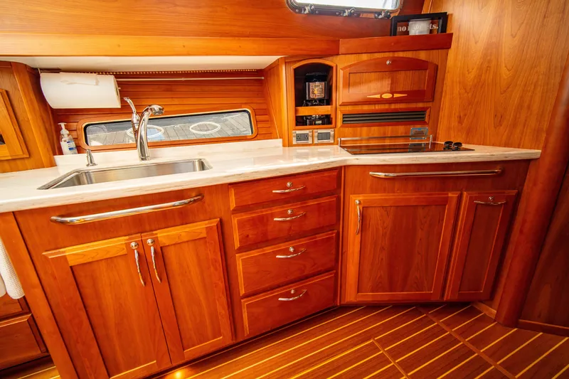 Slide: The Image of Luxurious 2015 Sabre 48 Salon Express yacht kitchen with wooden cabinetry and modern appliances. - 39
