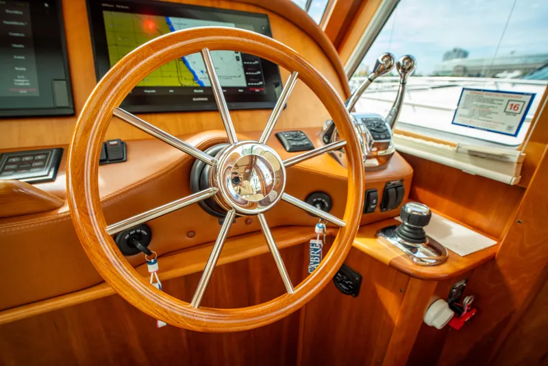 Slide: The Image of Steering wheel of 2015 Sabre 48 Salon Express yacht with navigation controls. - 4