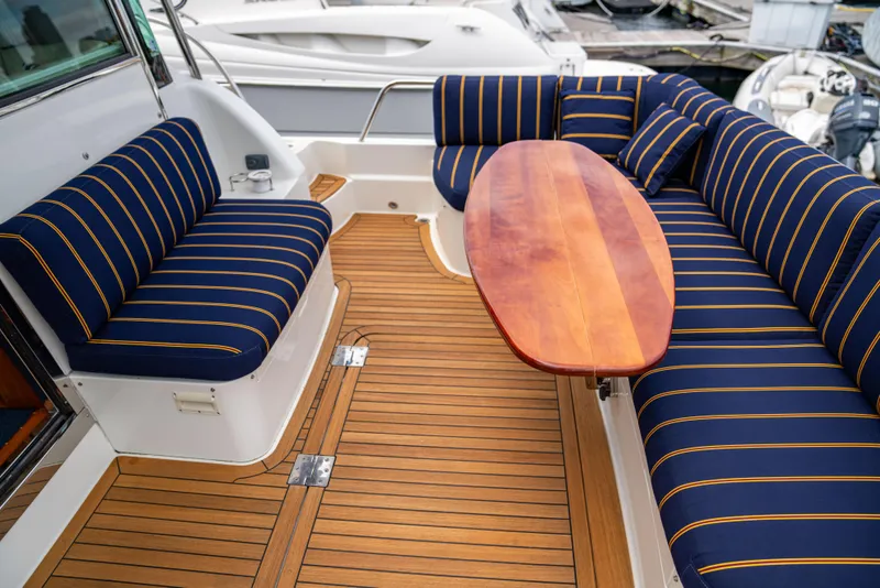 Slide: The Image of Luxurious 2015 Sabre 48 Salon Express yacht with striped seating and wooden deck. - 40
