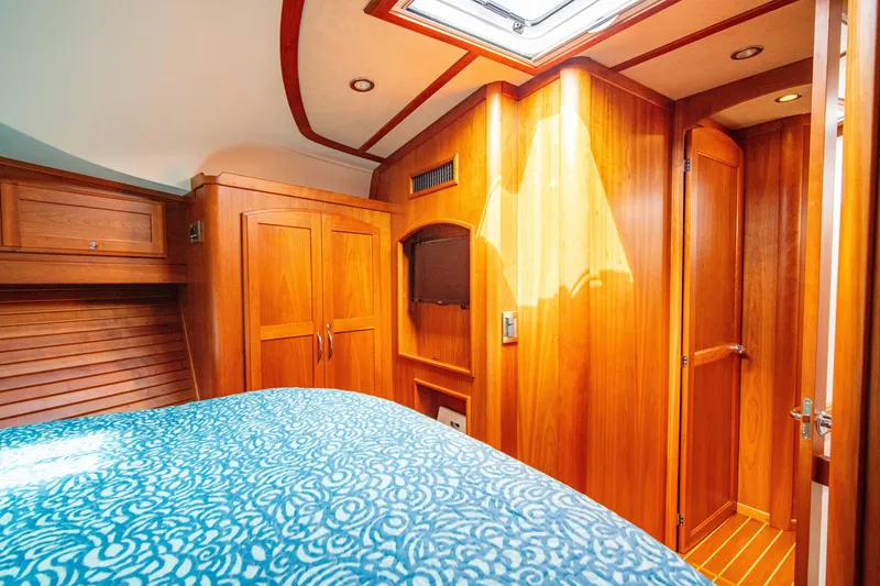 Slide: The Image of Luxurious 2015 Sabre 48 Salon Express cabin interior with wood finish and skylight. - 41