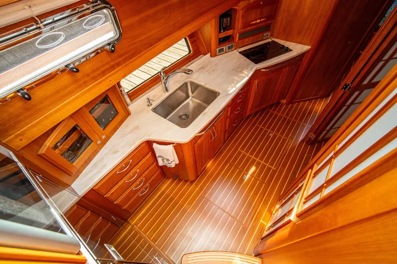Slide: The Image of Luxurious 2015 Sabre 48 Salon Express yacht kitchen with wood cabinetry and modern appliances. - 42