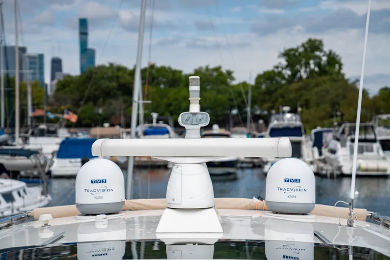 Slide: The Image of Sabre 48 Salon Express 2015 yacht with KVH TracVision domes in marina setting. - 43