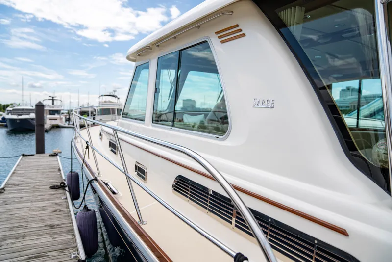 Slide: The Image of 2015 Sabre 48 Salon Express yacht docked at marina. - 44