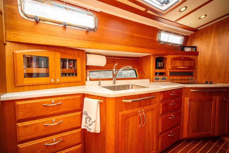 Slide: The Image of Luxurious 2015 Sabre 48 Salon Express yacht interior with elegant wooden cabinetry and modern fixtures. - 5
