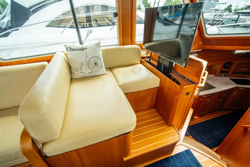 Slide: The Image of Interior of 2015 Sabre 48 Salon Express with beige seating and mounted TV. - 8