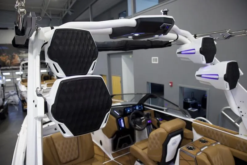 Slide: The Image of 2025 Malibu M242 boat interior with advanced audio system and luxurious seating. - 15