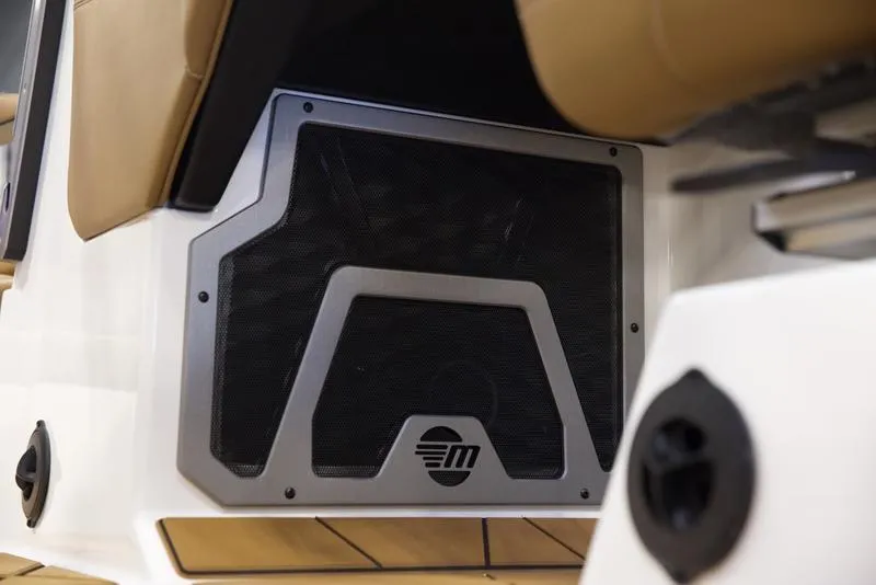 Slide: The Image of 2025 Malibu M242 boat interior speaker detail with sleek design. - 18
