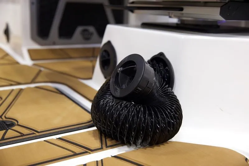 Slide: The Image of Malibu M242 2025 boat interior with coiled black hose on deck. - 19