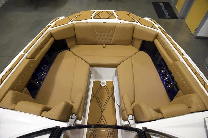 Slide: The Image of Luxurious interior of 2025 Malibu M242 boat with tan leather seating and cup holders. - 20