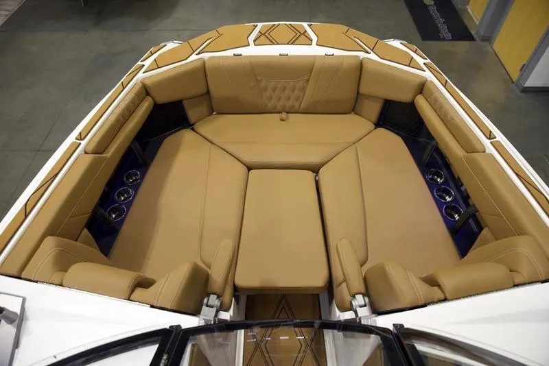 Slide: The Image of Luxurious interior of 2025 Malibu M242 boat with tan leather seating. - 21