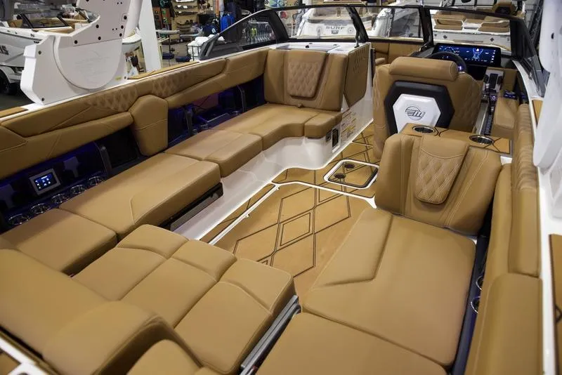 Slide: The Image of Luxurious interior of 2025 Malibu M242 boat with tan leather seating. - 22