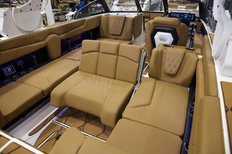 Slide: The Image of Luxurious interior of 2025 Malibu M242 boat with tan leather seating. - 24