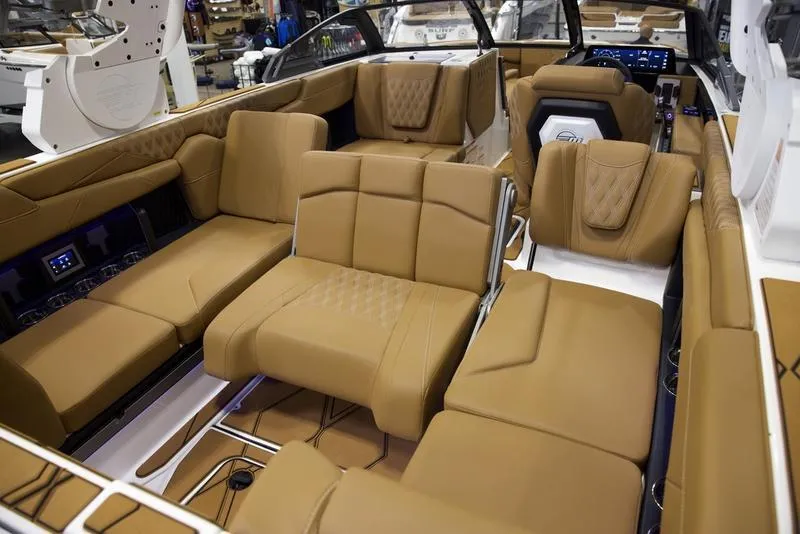 Slide: The Image of Luxurious interior of 2025 Malibu M242 boat with tan leather seating. - 25