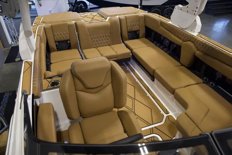 Slide: The Image of 2025 Malibu M242 boat interior with luxurious tan seating and modern design. - 26