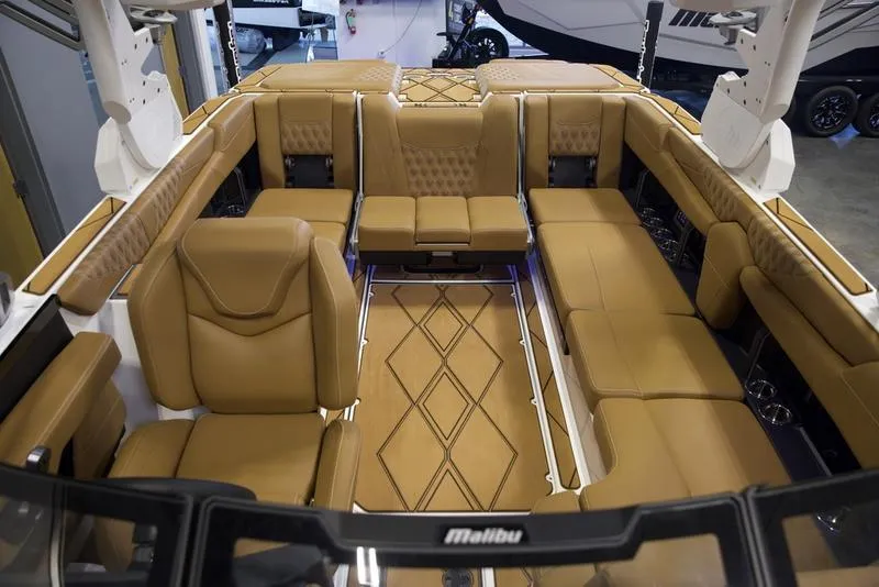 Slide: The Image of Luxurious interior of 2025 Malibu M242 boat with tan leather seating. - 27