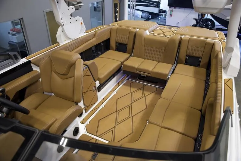 Slide: The Image of Luxurious interior of 2025 Malibu M242 boat with tan leather seating. - 28