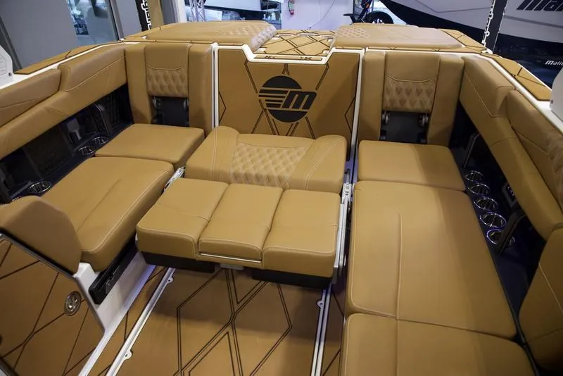 Slide: The Image of Luxurious interior of 2025 Malibu M242 boat with tan leather seating. - 29