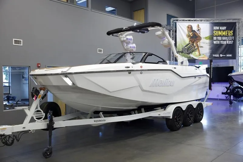 Slide: The Image of 2025 Malibu M242 boat on trailer in showroom. - 3