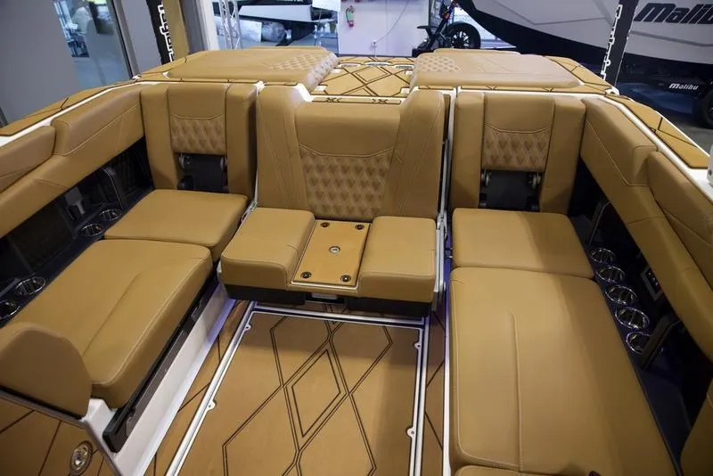 Slide: The Image of Luxurious interior of 2025 Malibu M242 boat with tan leather seating. - 30