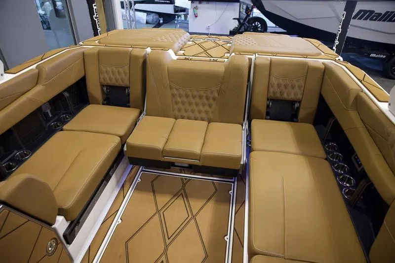 Slide: The Image of Luxurious interior of 2025 Malibu M242 boat with tan leather seating. - 31