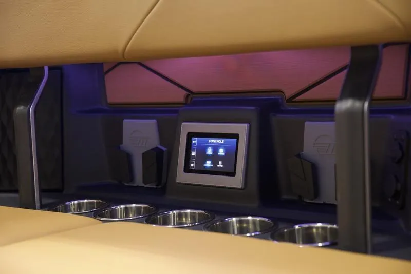 Slide: The Image of 2025 Malibu M242 interior with touchscreen controls and cup holders. - 33