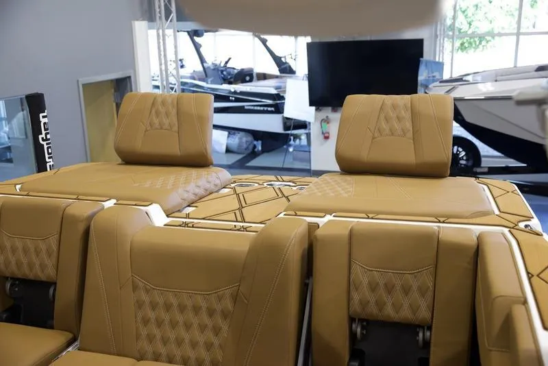 Slide: The Image of Luxurious interior of 2025 Malibu M242 boat with tan leather seating. - 36