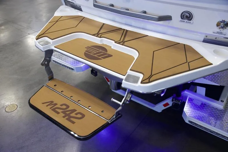 Slide: The Image of 2025 Malibu M242 boat swim platform with custom design and logo. - 6