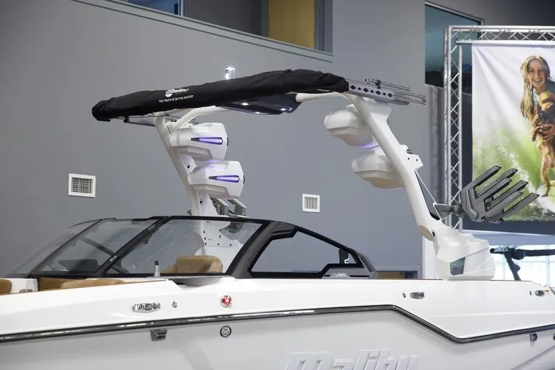 Slide: The Image of 2025 Malibu M242 boat with sleek design and advanced features in showroom. - 7