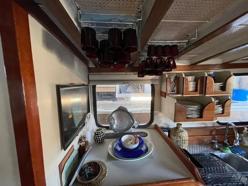 Slide: The Image of Interior of a 1940 Tacoma Boat Co Cruiser with vintage kitchen setup. - 10