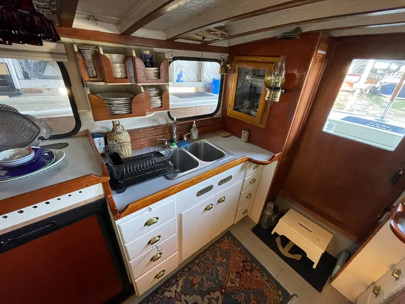 Slide: The Image of Interior of a 1940 Historic Tacoma Boat Co Cruiser with vintage kitchen setup. - 11