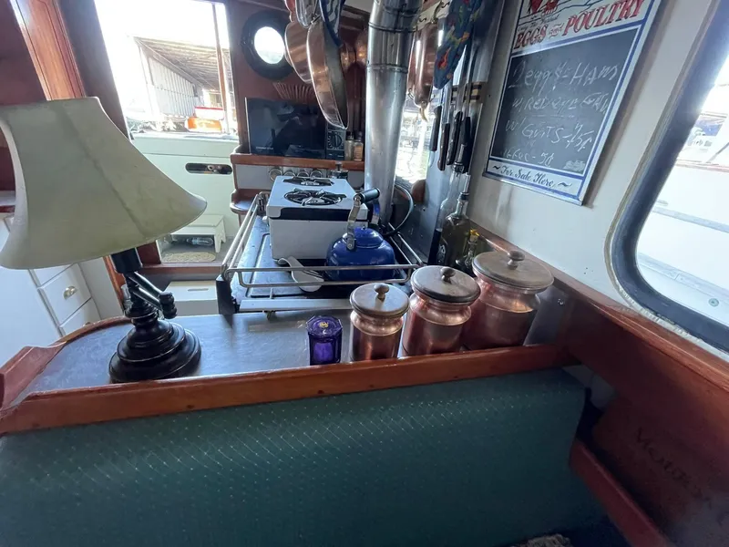 Slide: The Image of Interior of a 1940 Historic Tacoma Boat Co Cruiser with vintage kitchen setup. - 12