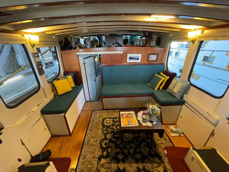 Slide: The Image of Interior of a 1940 Historic Tacoma Boat Co Cruiser with cozy seating and nautical decor. - 14