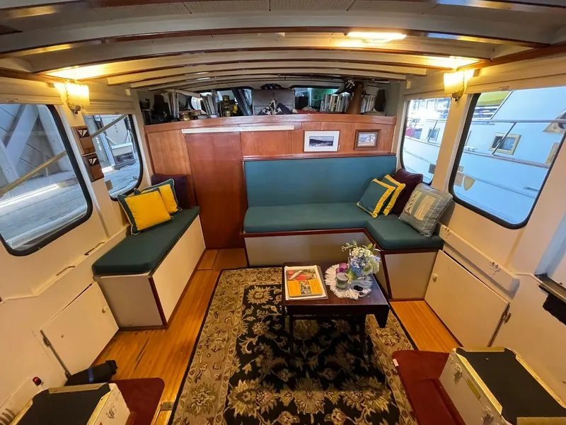 Slide: The Image of Interior of a 1940 Historic Tacoma Boat Co Cruiser with cozy seating and nautical decor. - 15