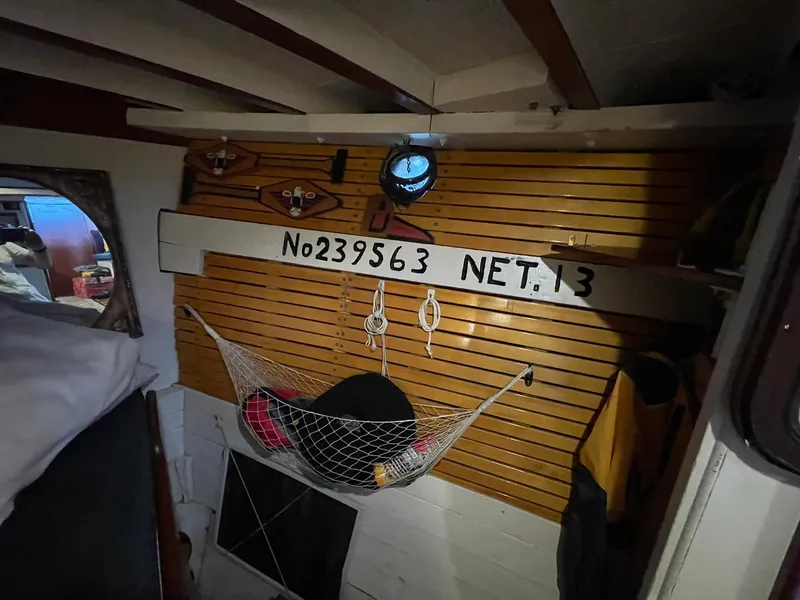 Slide: The Image of Interior of 1940 Historic Tacoma Boat Co Cruiser with nautical decor and storage net. - 26