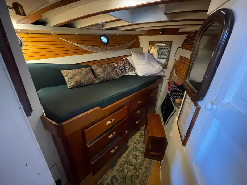 Slide: The Image of 1940 Historic Tacoma Boat Co Cruiser interior with cozy bed and wooden furnishings. - 28