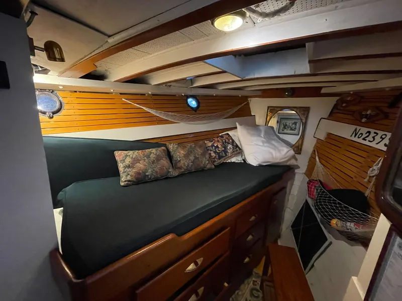 Slide: The Image of Cozy cabin interior of 1940 Historic Tacoma Boat Co Cruiser with wooden accents and bedding. - 29