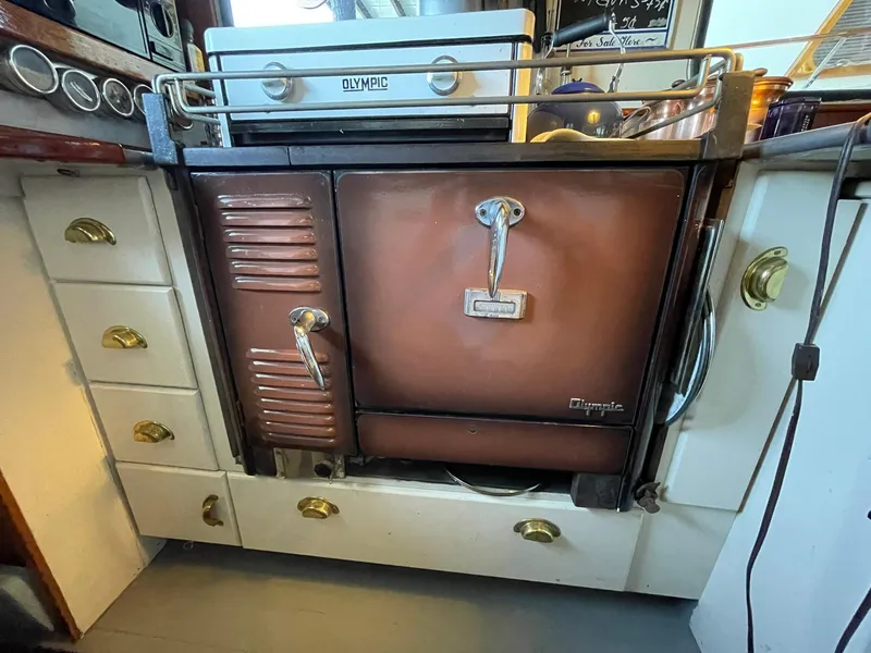 Slide: The Image of Vintage 1940 Olympic stove in a Historic Tacoma Boat Co Cruiser kitchen setting. - 3