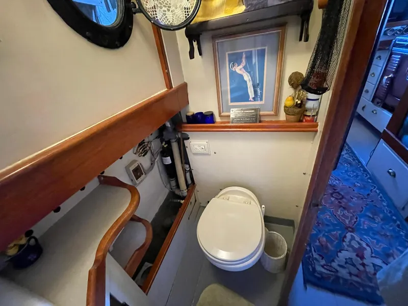 Slide: The Image of 1940 Historic Tacoma Boat Co Cruiser bathroom with nautical decor and framed artwork. - 32
